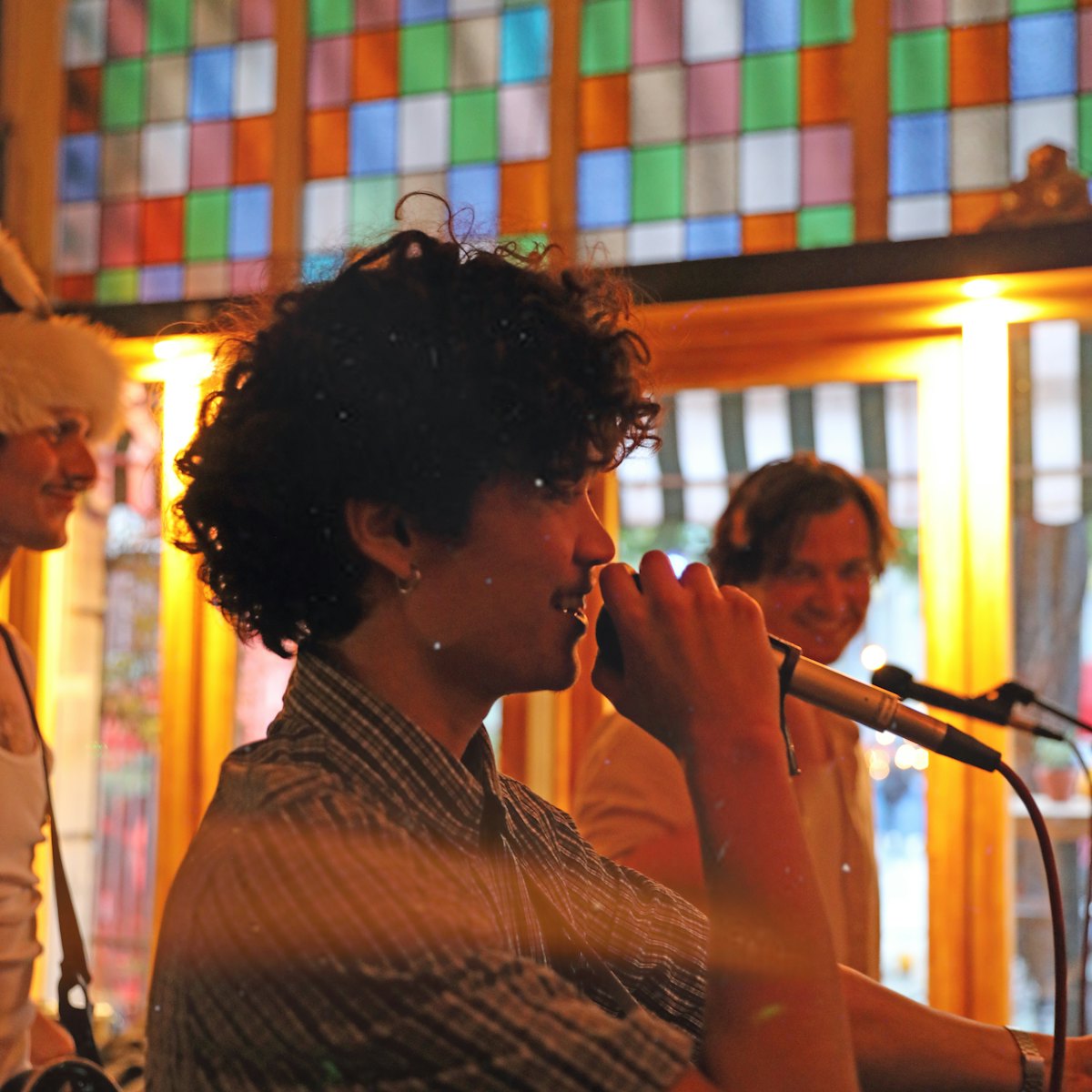 A musician playing guitar in a warmly lit cafe