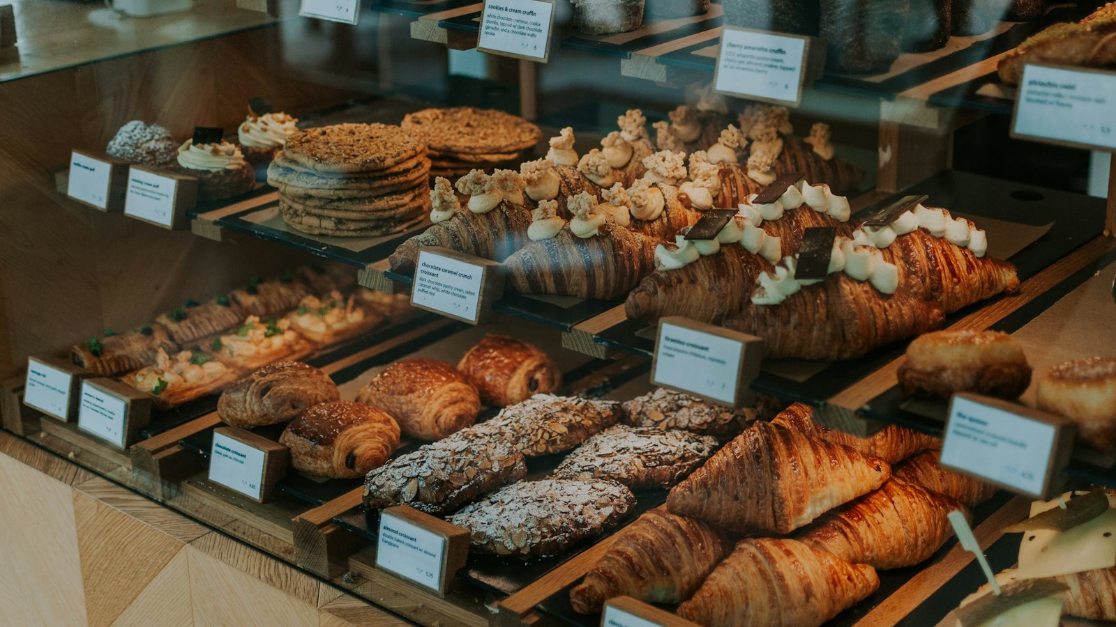 Croissants and pastries lined up in a bakery case