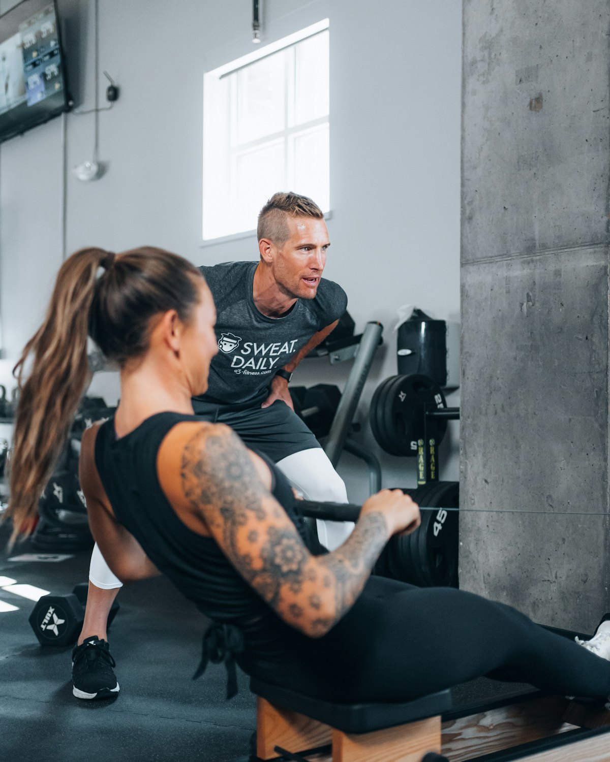 A coach and a member training together before class