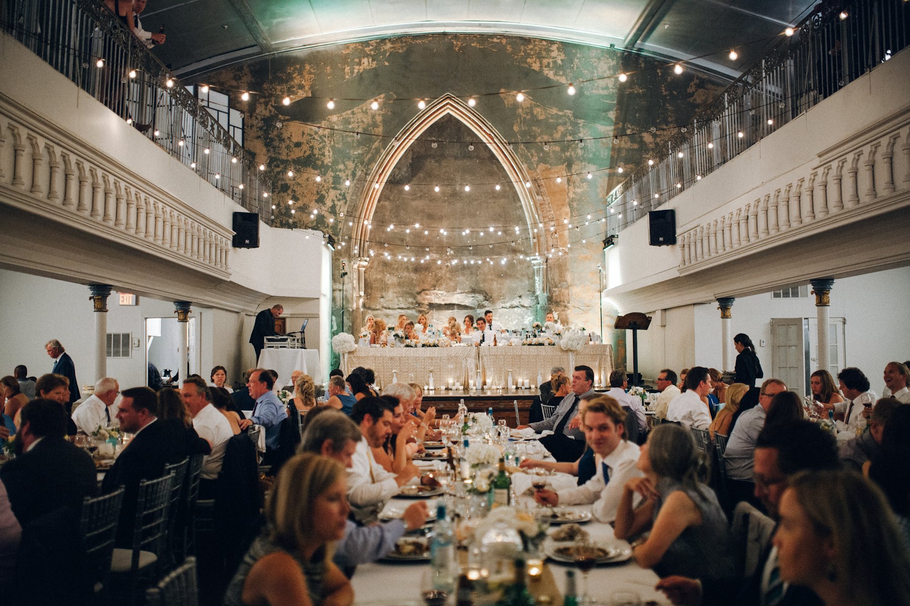 The reception hall full of guests at dinner
