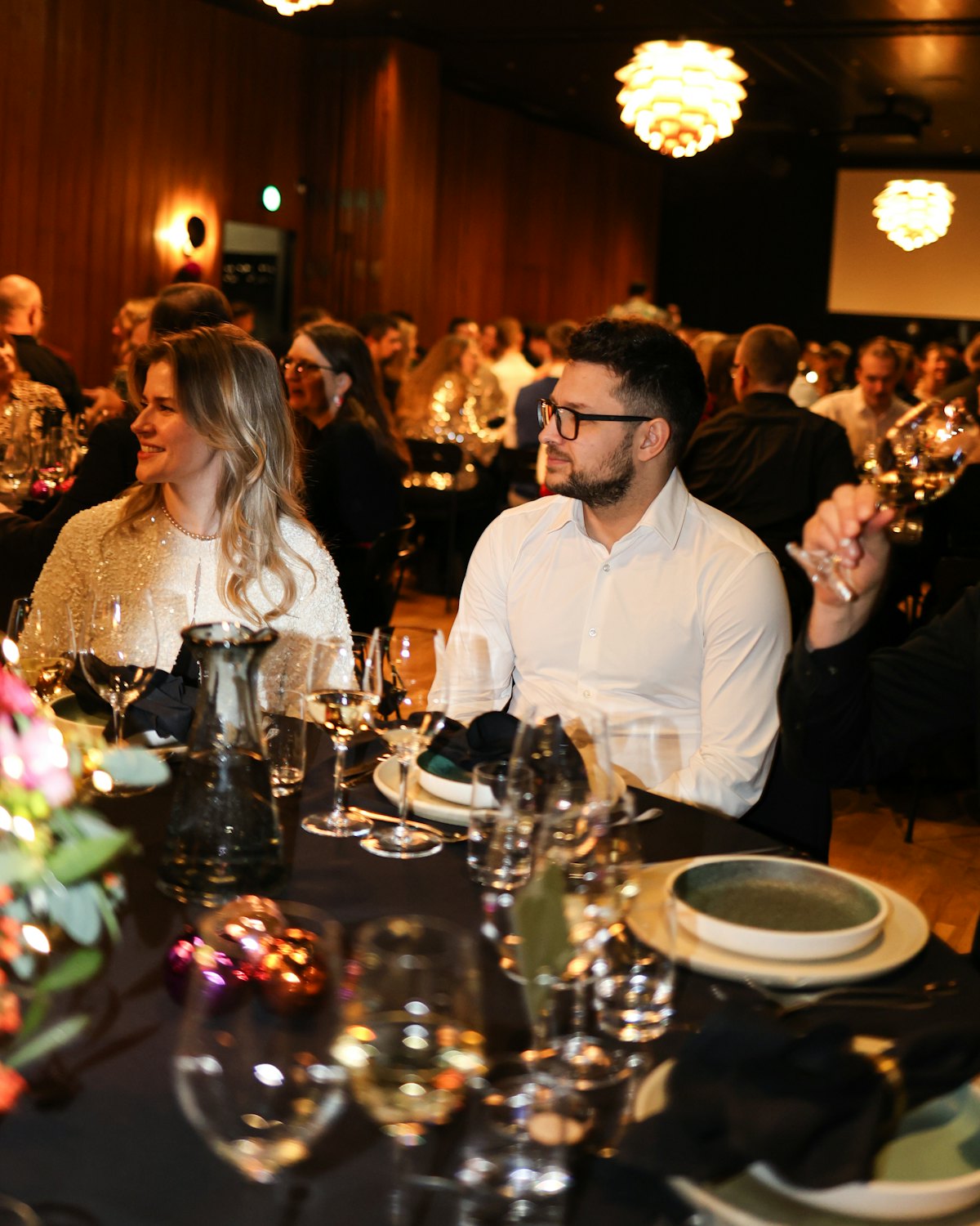 Guests at a candlelit dinner table at the spring gala