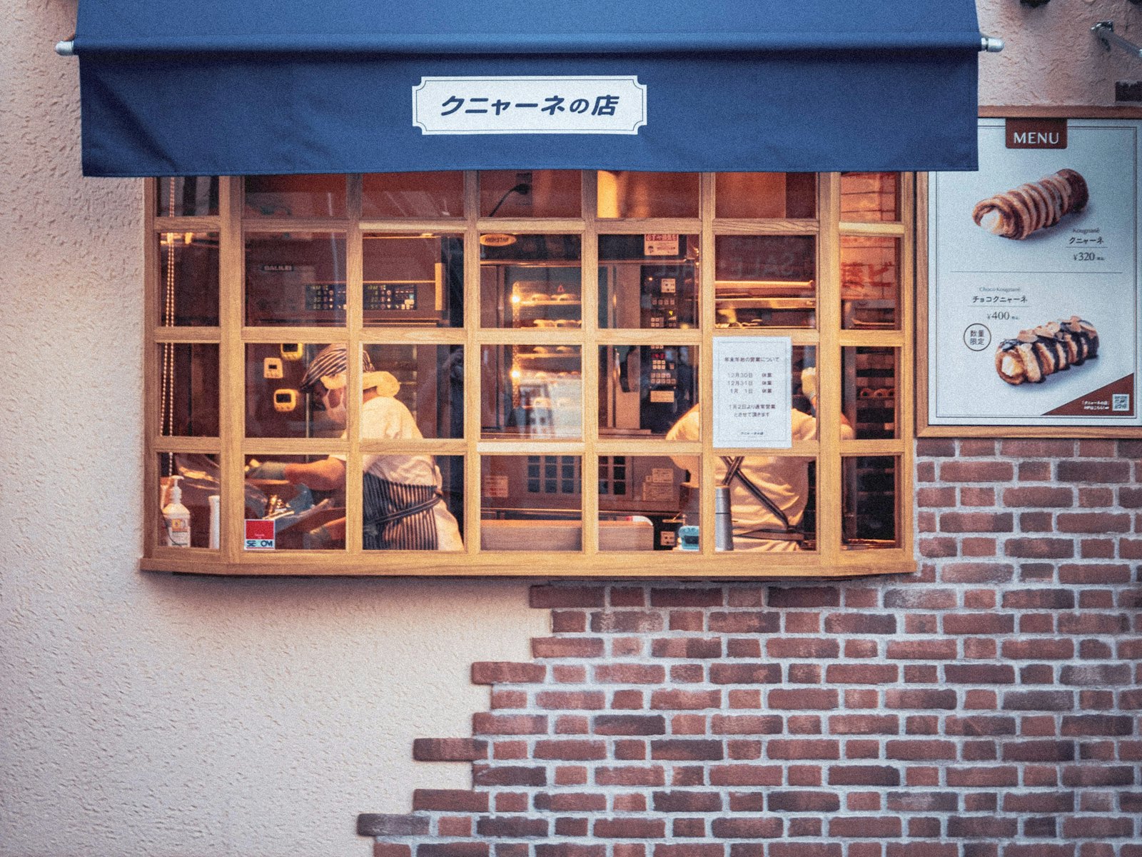 A bakery storefront with a blue awning