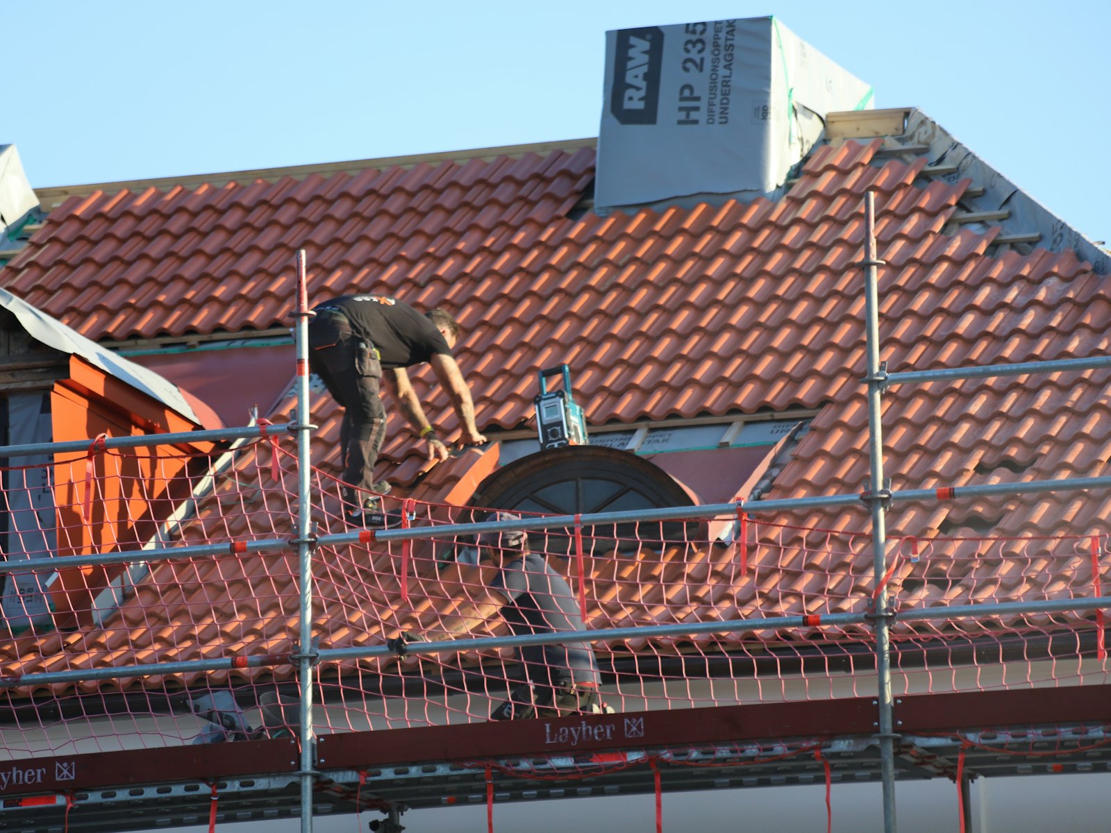 A roofer at work on a roof